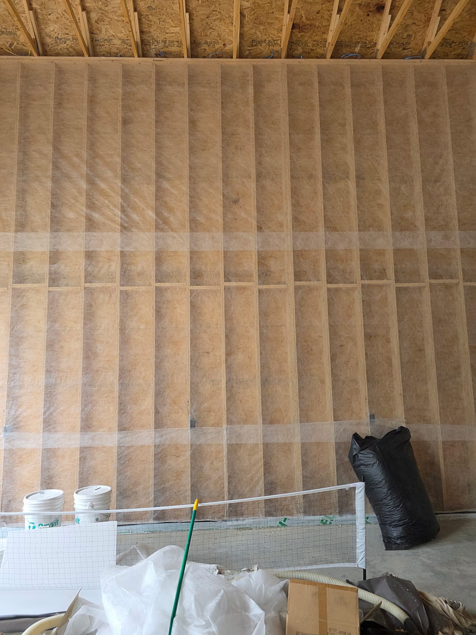 Batt insulation with vapor barrier installed between wall studs in a new-construction building, Sioux Falls, SD